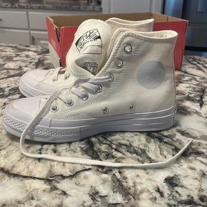 Cream colored high top converse